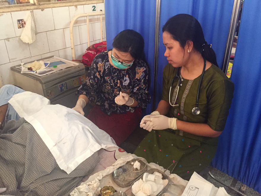 Dr Thin Zae Cho Oo (right) supervises a lumbar puncture performed by Dr Kyi Nyein Yin, one of the MARCH research officers.