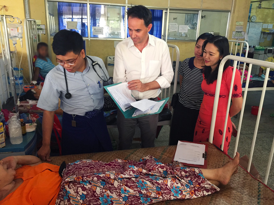 Dr Ne Myo Aung (left) talks to one of his patients during a ward round with Dr Josh Hanson, Dr Thin Zar Cho Oo and Dr Nan Phyu Sin Toe Myint.